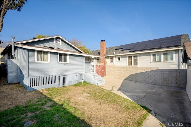 back of property featuring solar panels