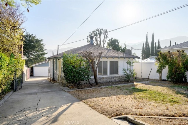 view of front of home with an outdoor structure and a garage