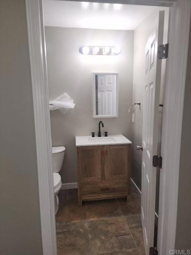 bathroom featuring toilet and vanity