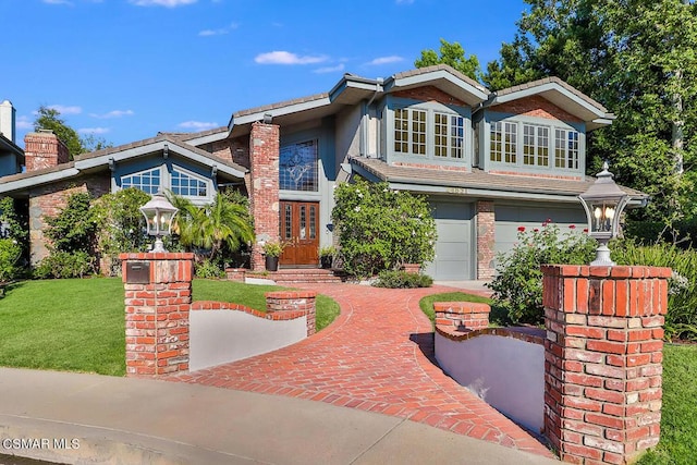 view of front of property featuring a front lawn and a garage