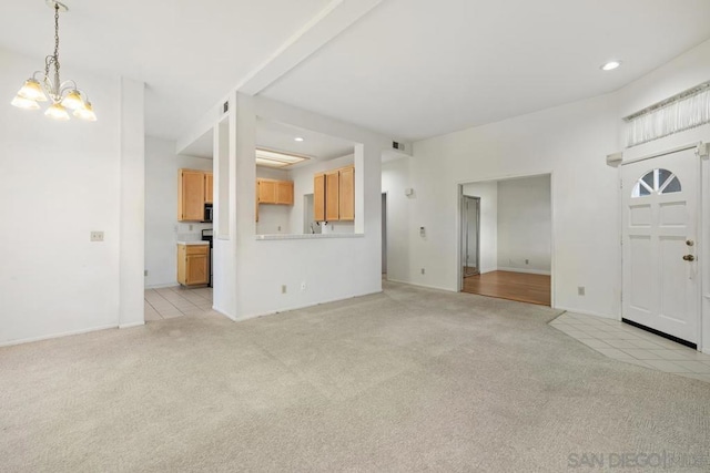 unfurnished living room with light carpet and a chandelier