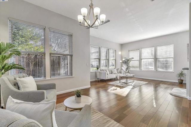 living room with dark hardwood / wood-style flooring and a chandelier