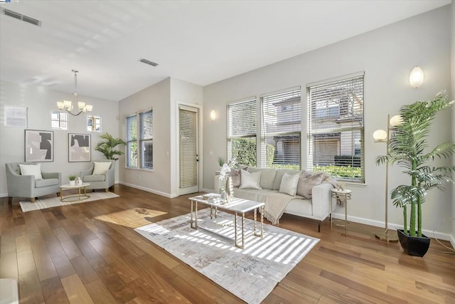 living room with hardwood / wood-style floors and a chandelier