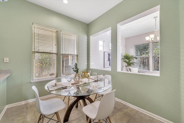 dining space featuring a notable chandelier and light tile patterned floors