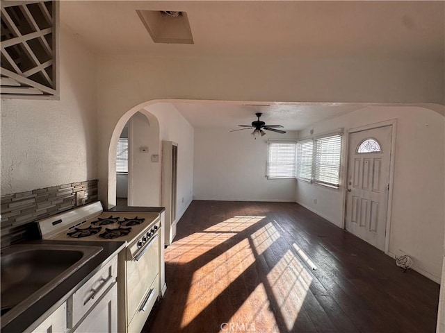 kitchen featuring white cabinets, backsplash, dark hardwood / wood-style floors, ceiling fan, and white range