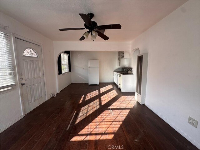 foyer featuring ceiling fan and dark hardwood / wood-style flooring