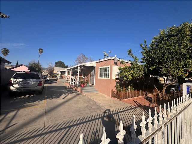 view of front of property with fence and stucco siding