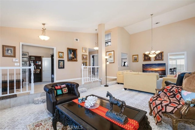 living room with lofted ceiling, light carpet, and an inviting chandelier