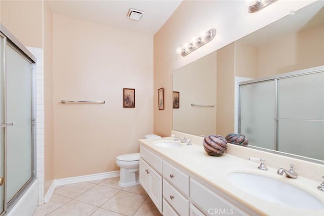 full bathroom featuring toilet, combined bath / shower with glass door, tile patterned flooring, and vanity