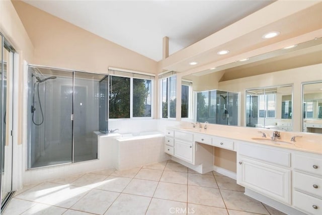 bathroom featuring a healthy amount of sunlight, shower with separate bathtub, lofted ceiling, and vanity