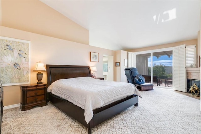 bedroom featuring vaulted ceiling and access to exterior