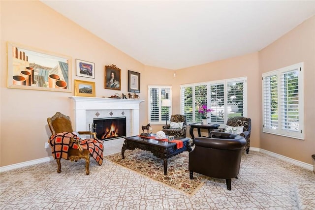 living room with lofted ceiling and a tiled fireplace