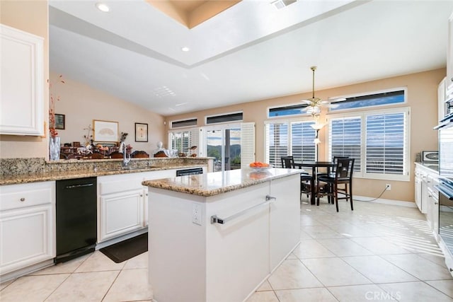 kitchen with light stone countertops, white cabinetry, sink, kitchen peninsula, and light tile patterned flooring