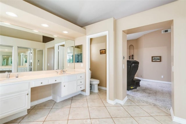 bathroom featuring toilet, vanity, and tile patterned flooring