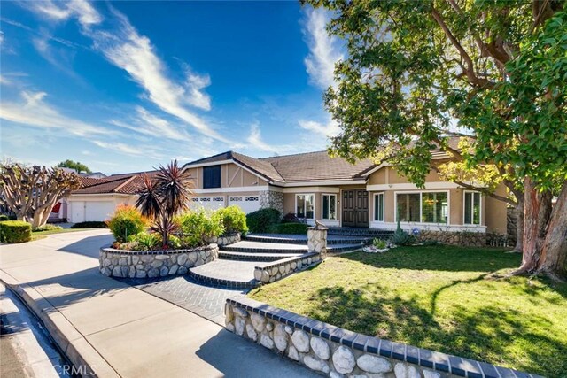 view of front of home with a garage and a front yard