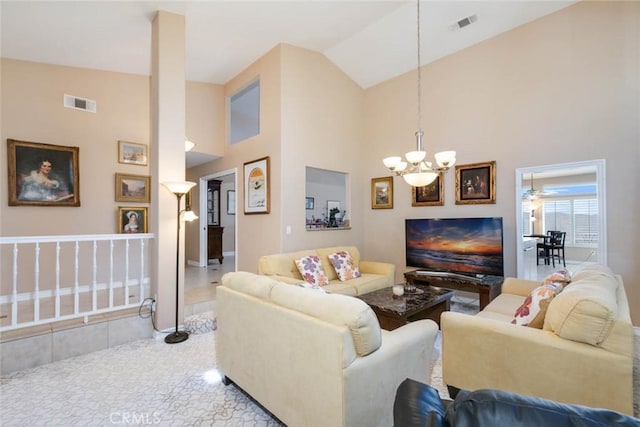 living room featuring ceiling fan with notable chandelier and high vaulted ceiling