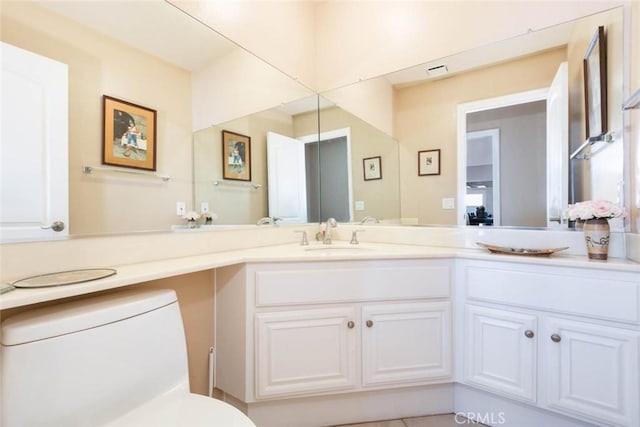 bathroom with toilet and vanity