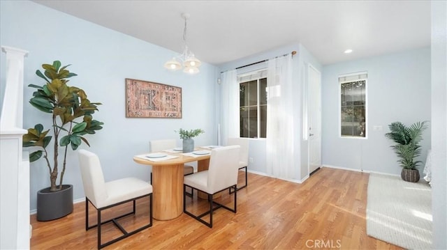 dining room with a chandelier and light wood-type flooring