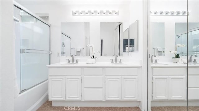 bathroom with bath / shower combo with glass door and vanity