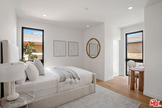 bedroom featuring light hardwood / wood-style floors and multiple windows