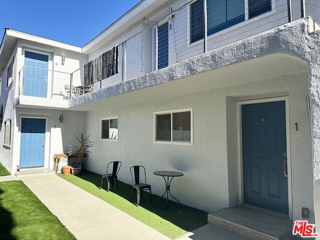 entrance to property with a balcony