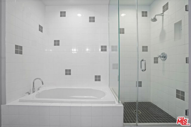 bathroom with shower with separate bathtub