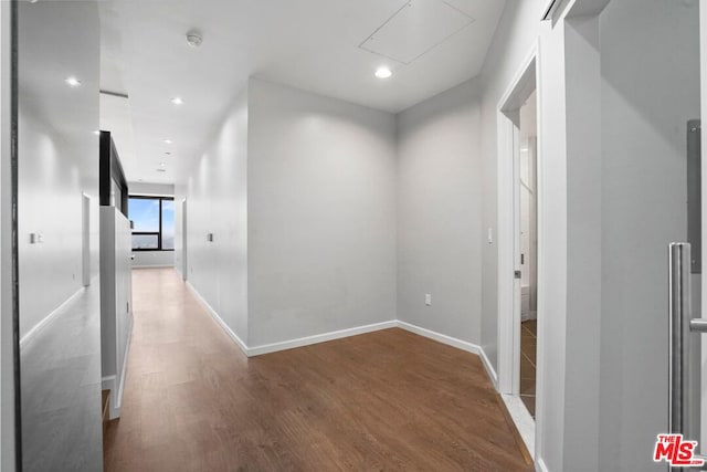 corridor featuring wood-type flooring