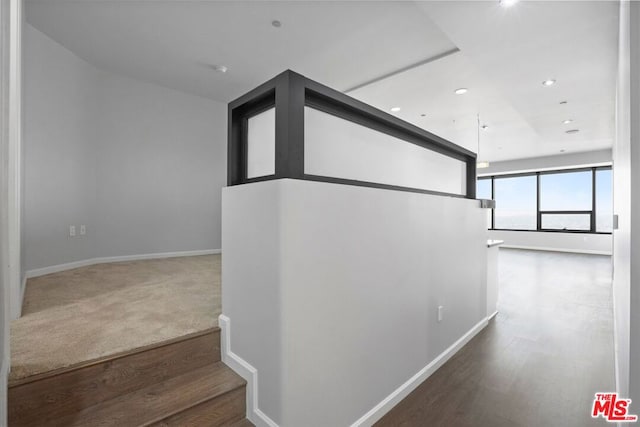 staircase with hardwood / wood-style flooring