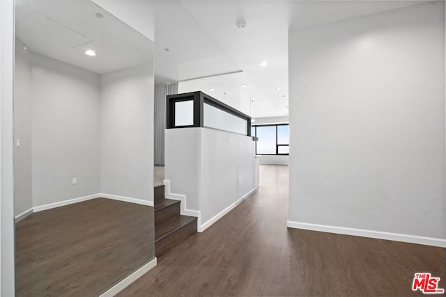 hallway with dark hardwood / wood-style floors