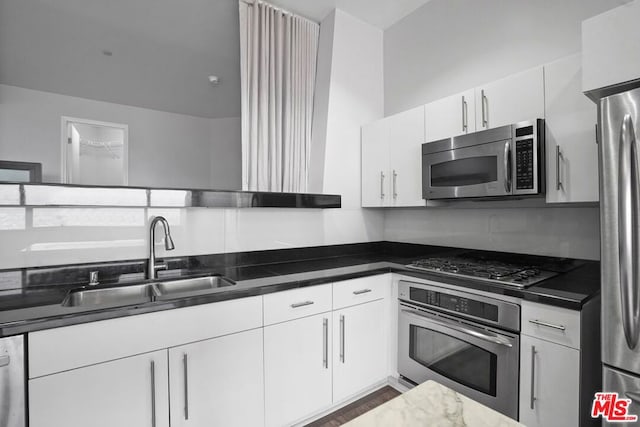 kitchen featuring sink, white cabinets, and stainless steel appliances