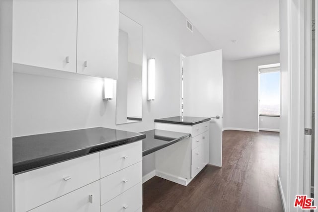 kitchen with white cabinetry and dark wood-type flooring