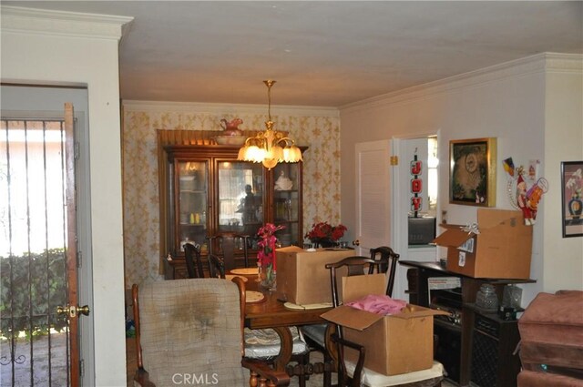 dining room with a wealth of natural light, crown molding, and a notable chandelier