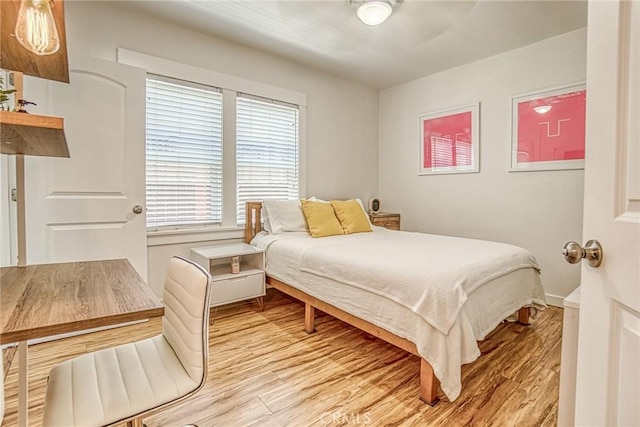 bedroom with light wood-type flooring and ceiling fan