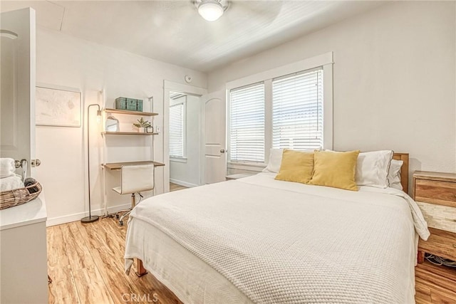 bedroom featuring ceiling fan and light hardwood / wood-style flooring