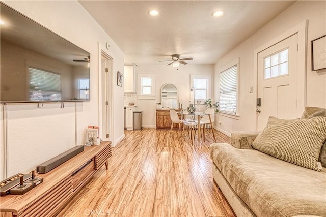 living room with ceiling fan and light hardwood / wood-style floors