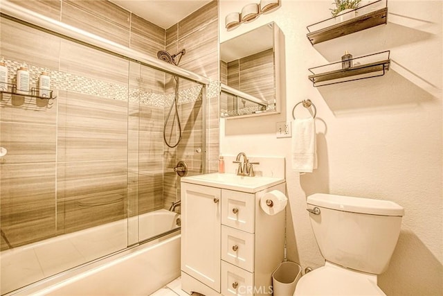 full bathroom featuring enclosed tub / shower combo, vanity, and toilet