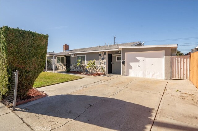 ranch-style house with a front yard and a garage