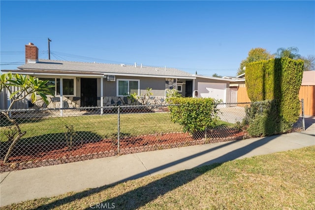 ranch-style house with a garage and a front lawn