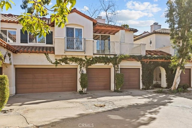 mediterranean / spanish-style house featuring a balcony and a garage