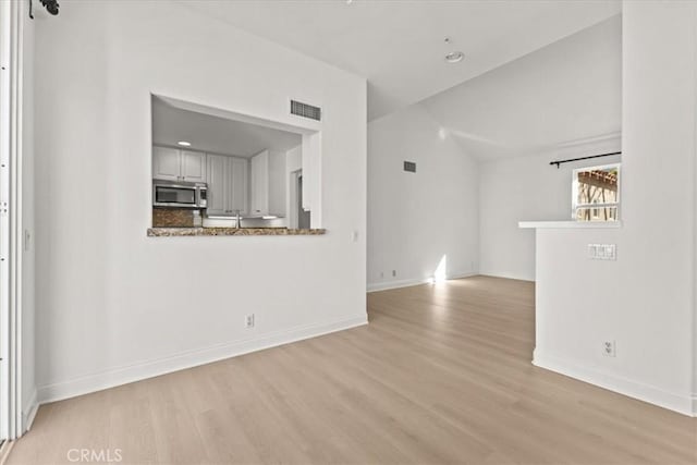 unfurnished living room featuring light hardwood / wood-style flooring