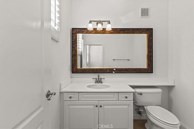 bathroom with toilet and vanity