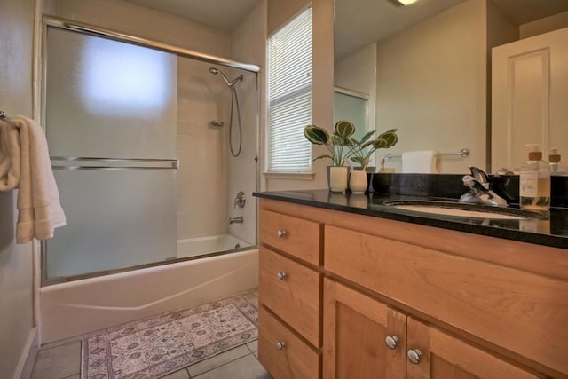 bathroom featuring vanity, tile patterned floors, and shower / bath combination with glass door