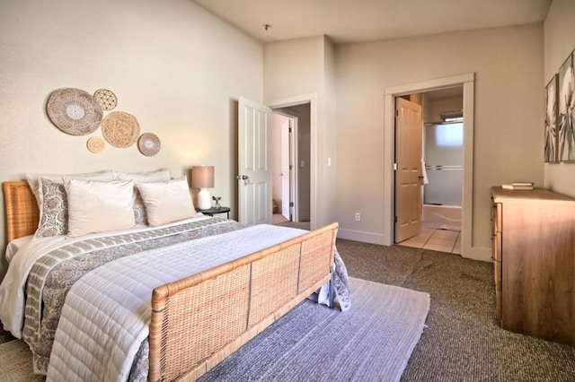 carpeted bedroom with vaulted ceiling and connected bathroom