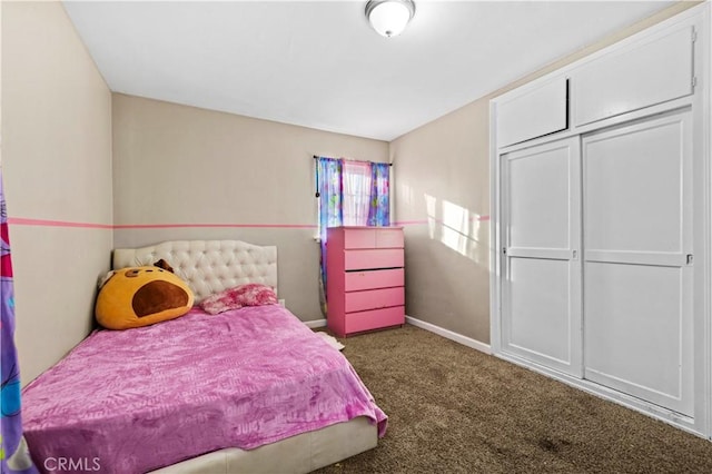 bedroom featuring a closet and dark colored carpet