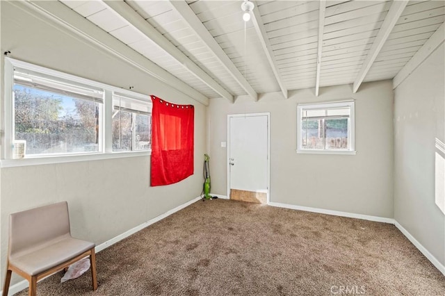 unfurnished room with carpet floors and lofted ceiling with beams