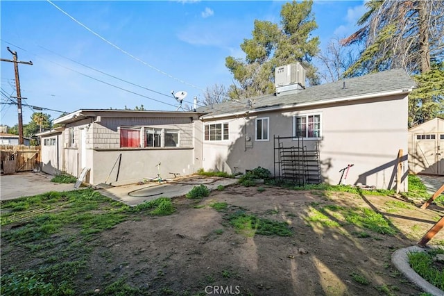 back of house featuring central air condition unit and a patio