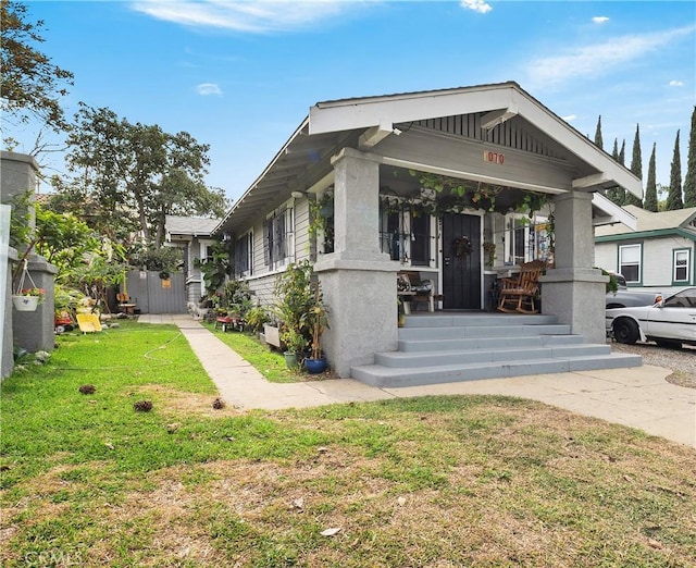 view of front of house with a front lawn and a porch