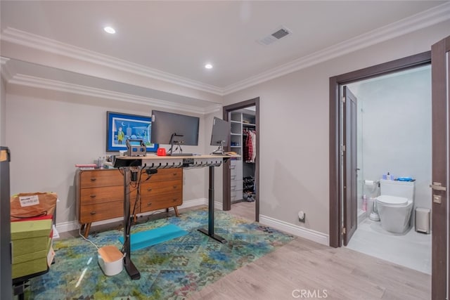 bedroom featuring ensuite bath, wood-type flooring, and crown molding