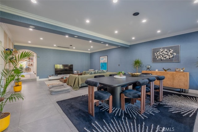 dining space with light tile patterned floors and crown molding