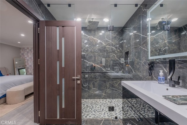 bathroom featuring a shower with shower door and crown molding